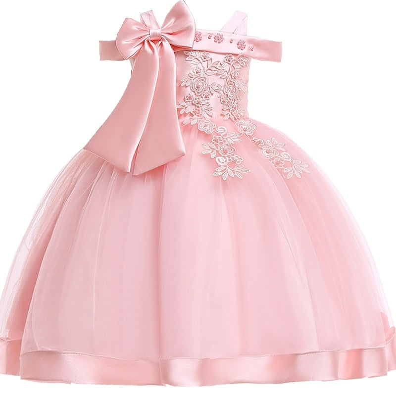 Party dress with bow and appliqué for ages 3 to 10.