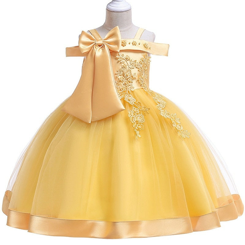 Party dress with bow and appliqué for ages 3 to 10.