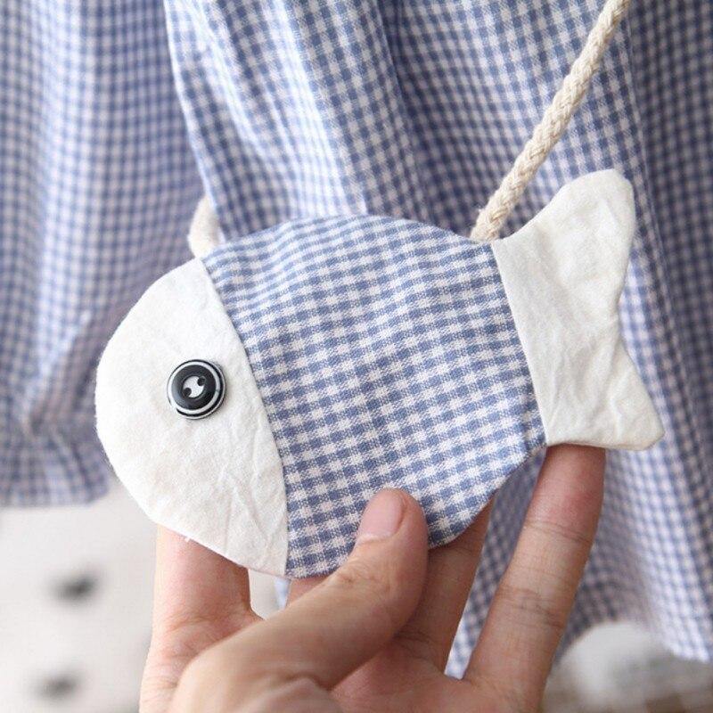 Checkered dress with fish-shaped purse.