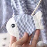 Checkered dress with fish-shaped purse.
