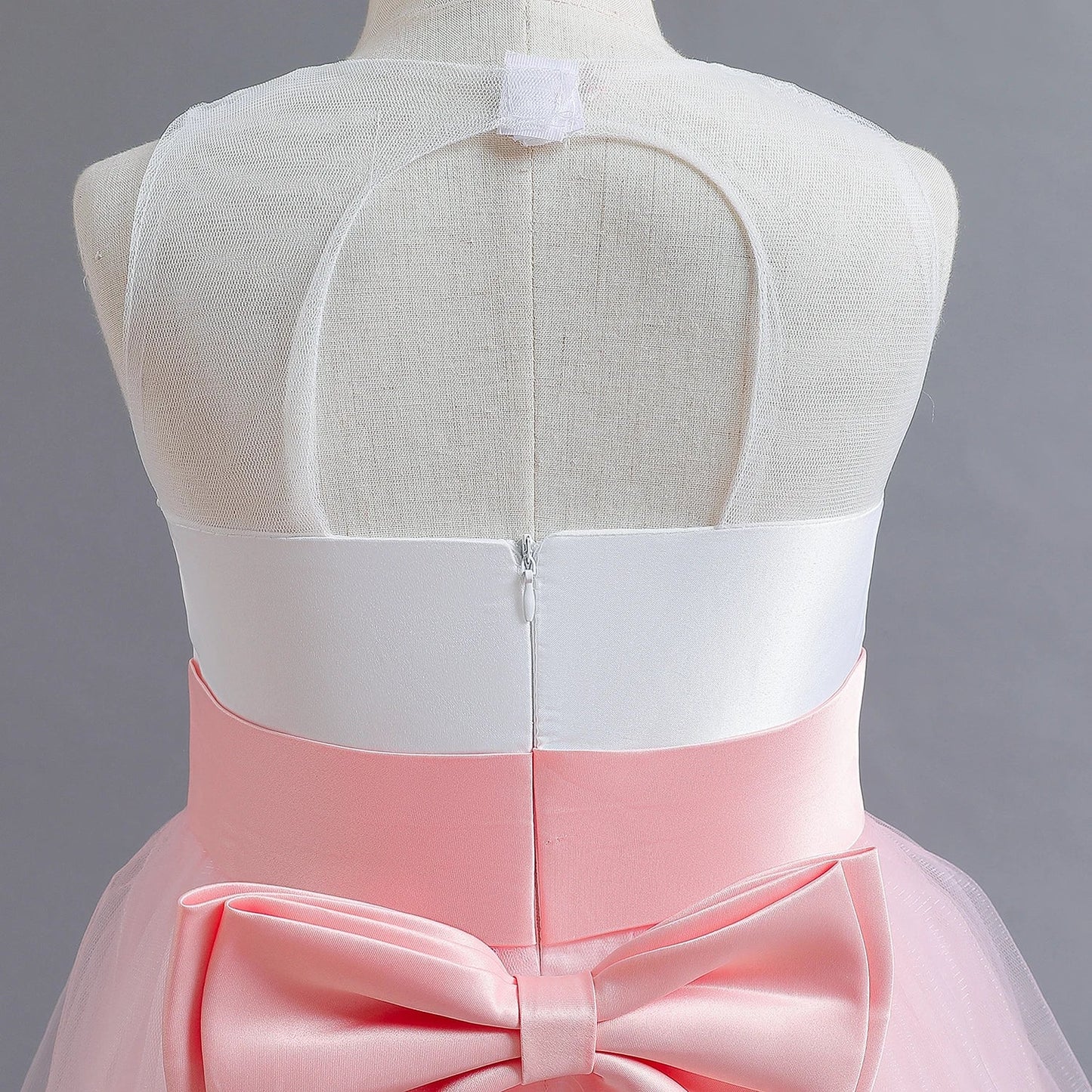 Long Kids party dress made of lace with embroidered flowers, bows, rhinestones, and sequins.