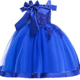 Party dress with bow and appliqué for ages 3 to 10.