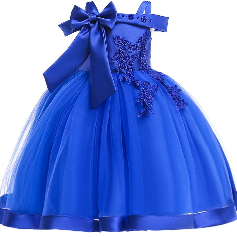 Party dress with bow and appliqué for ages 3 to 10.