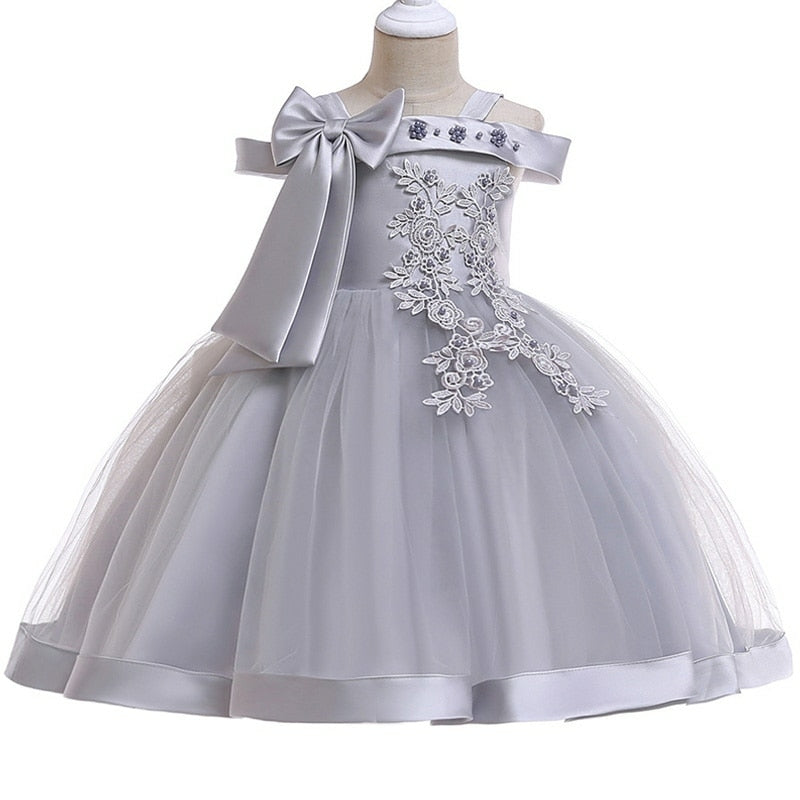 Party dress with bow and appliqué for ages 3 to 10.