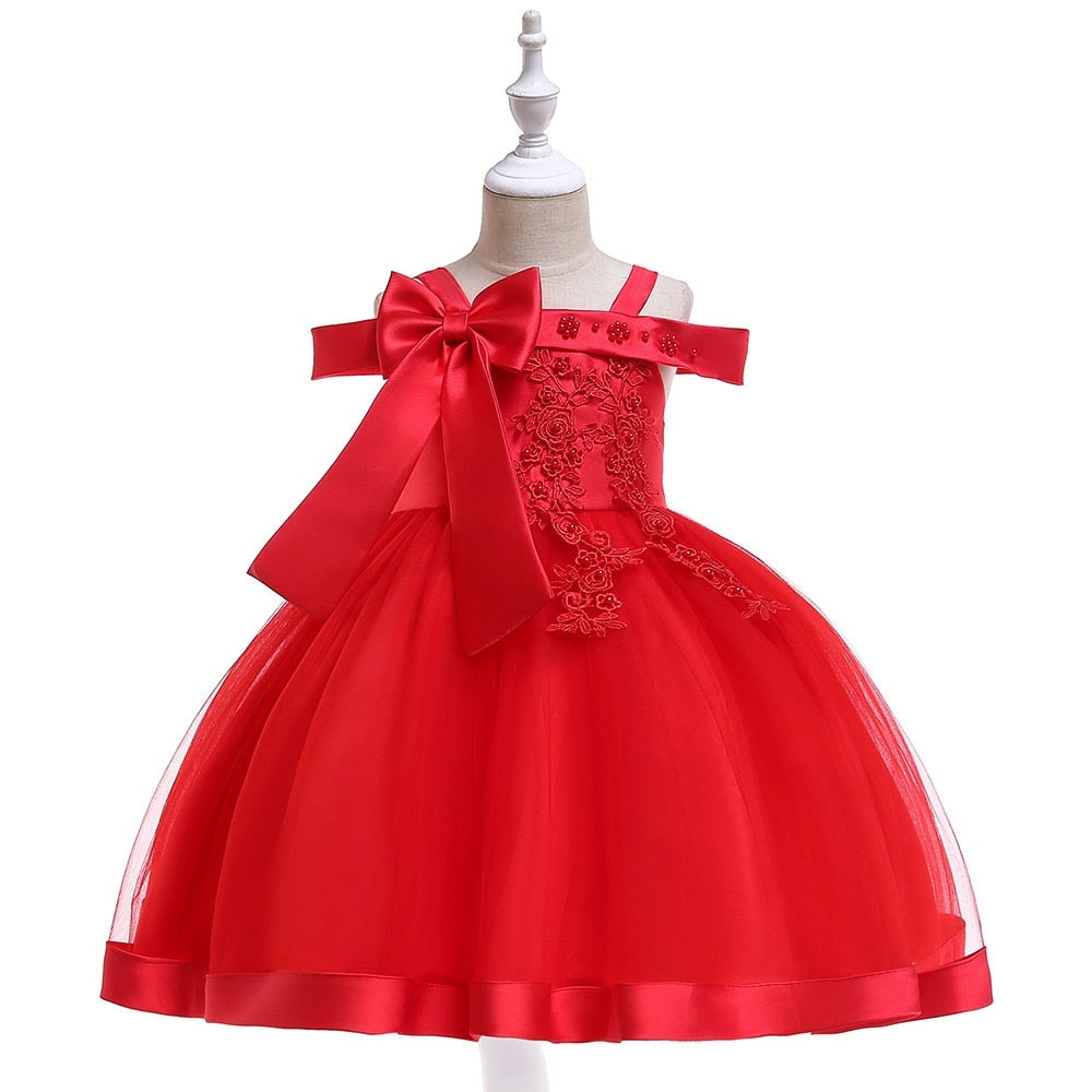 Party dress with bow and appliqué for ages 3 to 10.
