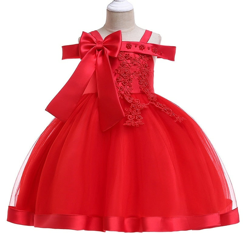 Party dress with bow and appliqué for ages 3 to 10.