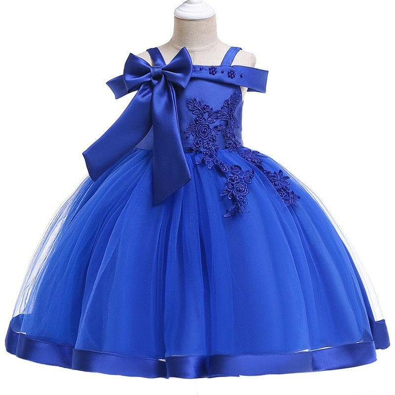 Party dress with bow and appliqué for ages 3 to 10.