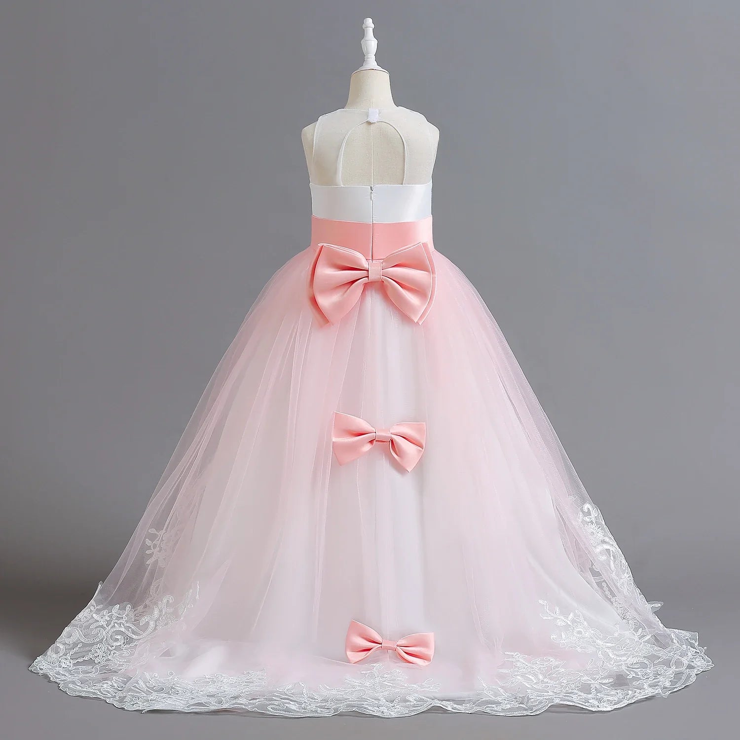 Long Kids party dress made of lace with embroidered flowers, bows, rhinestones, and sequins.