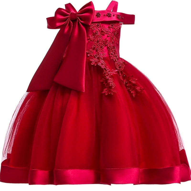 Party dress with bow and appliqué for ages 3 to 10.