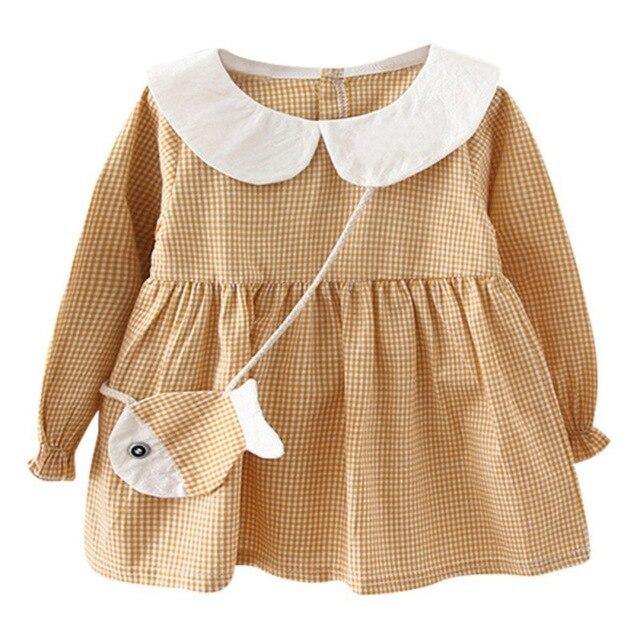 Checkered dress with fish-shaped purse.