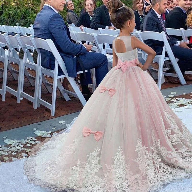 Long Kids party dress made of lace with embroidered flowers, bows, rhinestones, and sequins.