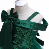 Party dress with bow and appliqué for ages 3 to 10.