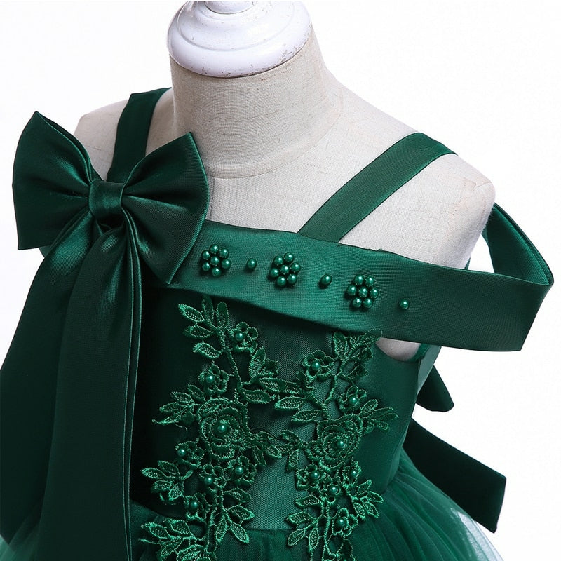 Party dress with bow and appliqué for ages 3 to 10.