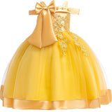 Party dress with bow and appliqué for ages 3 to 10.