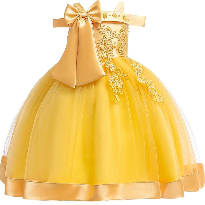 Party dress with bow and appliqué for ages 3 to 10.