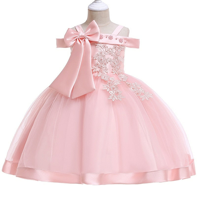 Party dress with bow and appliqué for ages 3 to 10.