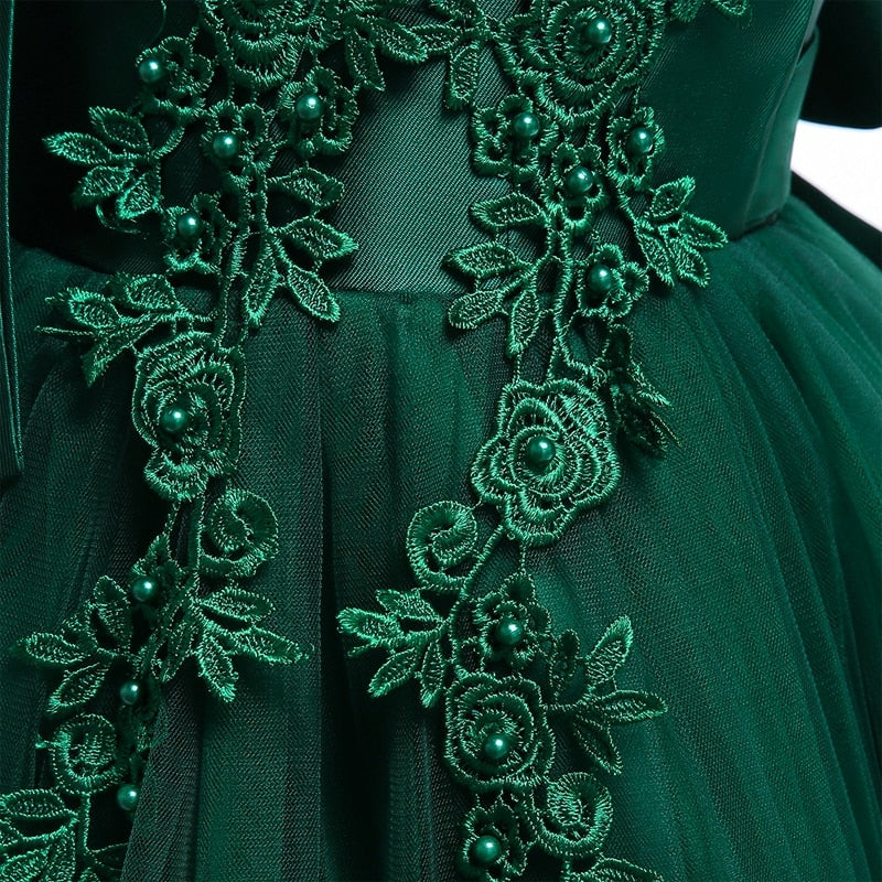 Party dress with bow and appliqué for ages 3 to 10.