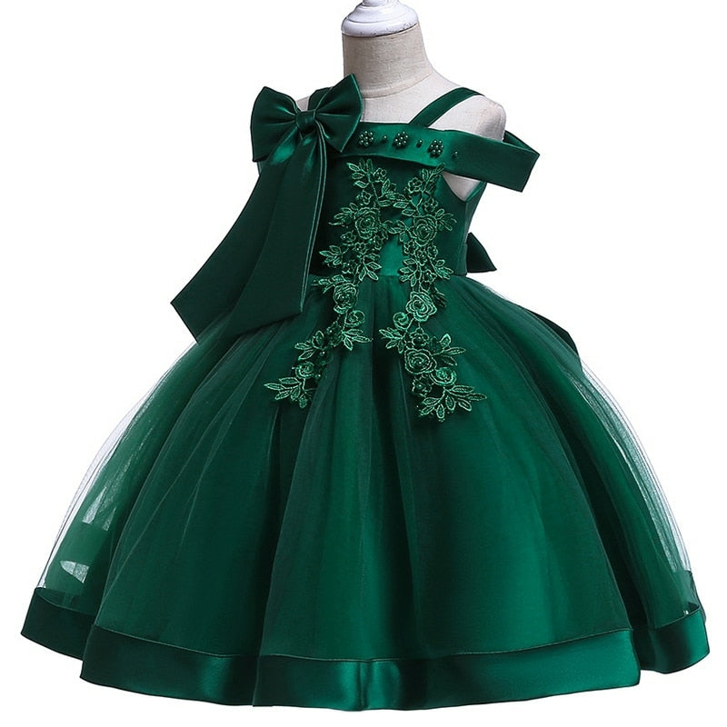 Party dress with bow and appliqué for ages 3 to 10.