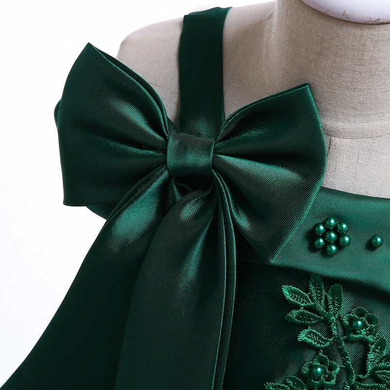 Party dress with bow and appliqué for ages 3 to 10.