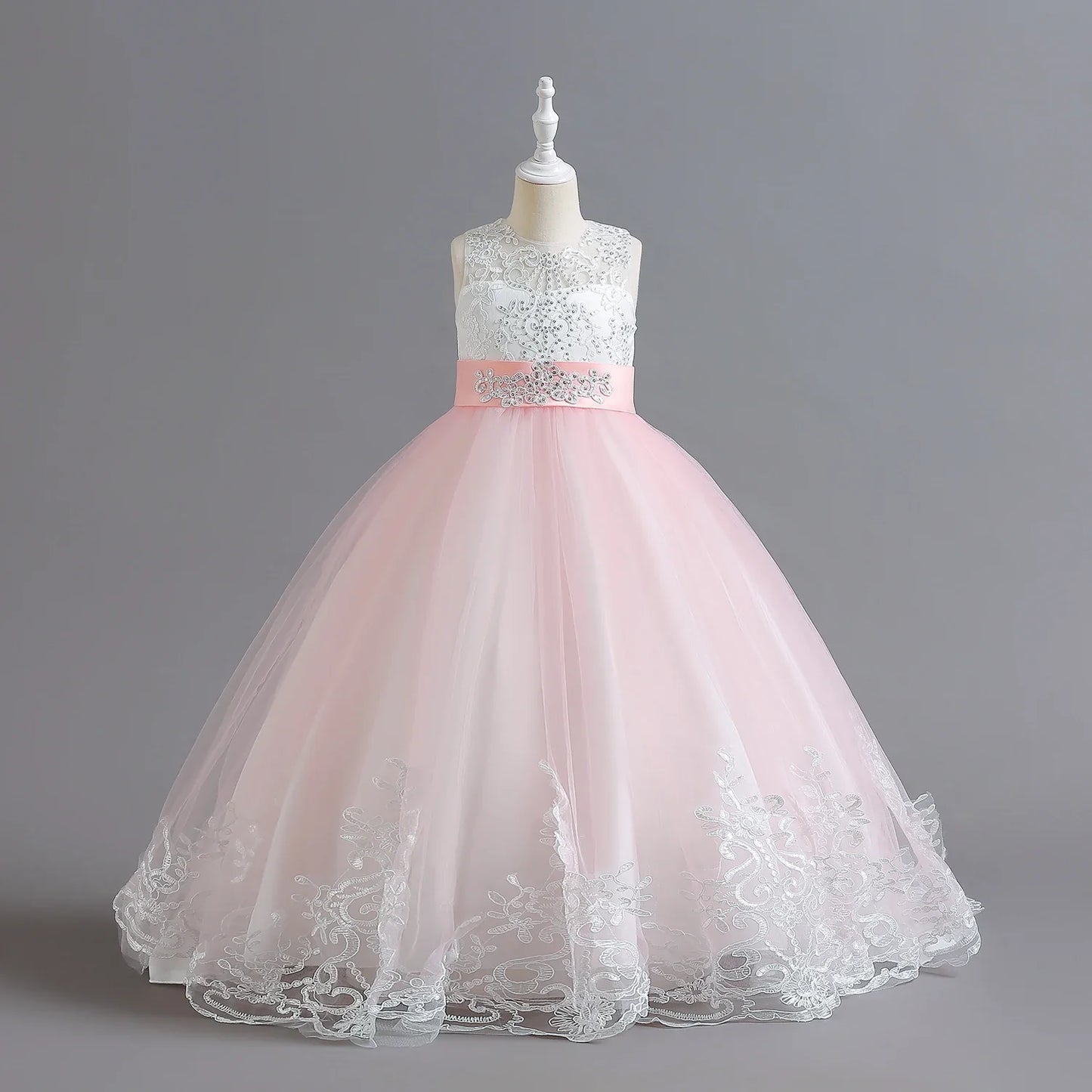 Long Kids party dress made of lace with embroidered flowers, bows, rhinestones, and sequins.