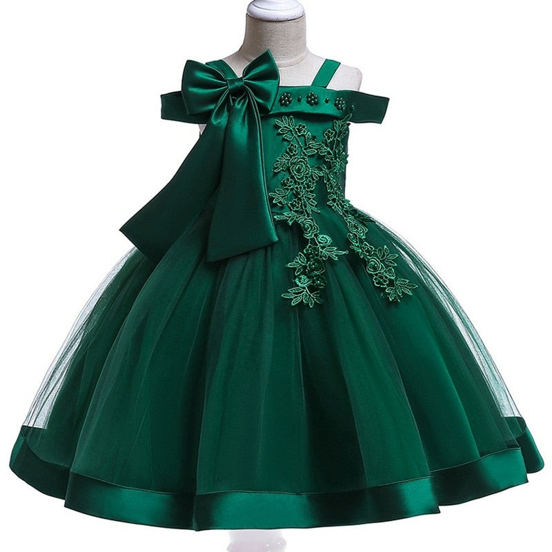 Party dress with bow and appliqué for ages 3 to 10.