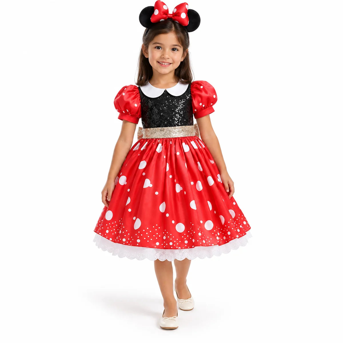 Minnie Mouse red heart-print dress with black bodice, white collar, puff sleeves and matching mouse-ear headband, worn by a child.