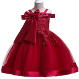 Party dress with bow and appliqué for ages 3 to 10.