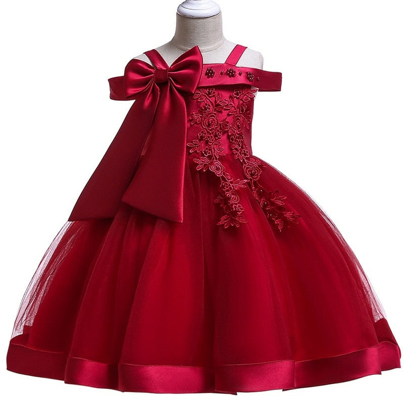 Party dress with bow and appliqué for ages 3 to 10.